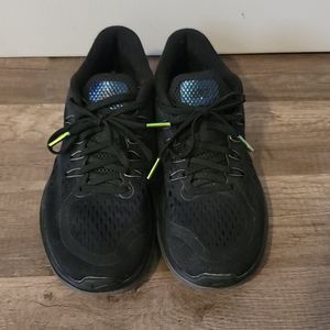 Black nike running shoes with iridescent details